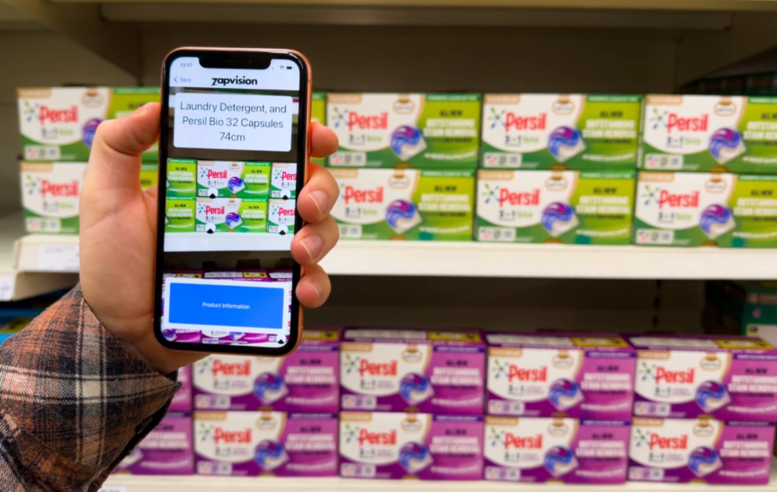 Zapvision announcing Persil Bio 32 Capsules and its distance, held up to a supermarket shelf